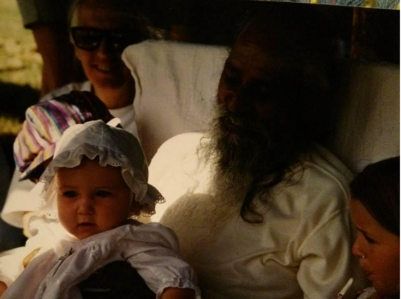 Baby Arpita being held by Babaji