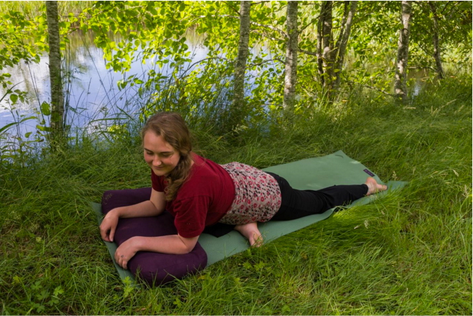 Propping your forearms on a bolster can help you ease slowly into the pose, or stay at your edge if that is where your edge is.