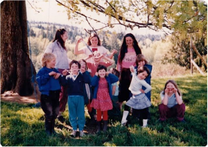 Some of the kids - and a couple of adults -in March, 1984. Back row: Usha, Maicha; front row: Rohan, Kerry, Ariel behind Kerry, Maya, SunMoon, Tzigani, ,Nayana, Sunya behind Nayana, Ananda . Missing from this photo are Rajom, Fainne and Uma. Between Usha and Maicha is someone we can’t identify; if you know who it is, please let us know.