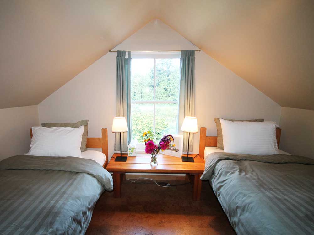 Shared guest room at The Salt Spring Centre of Yoga for programs, accommodations, and rentals.