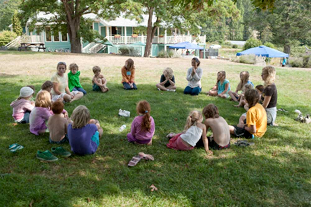 Children in a circle at a yoga and wellness retreat at the Salt Spring Centre of Yoga
