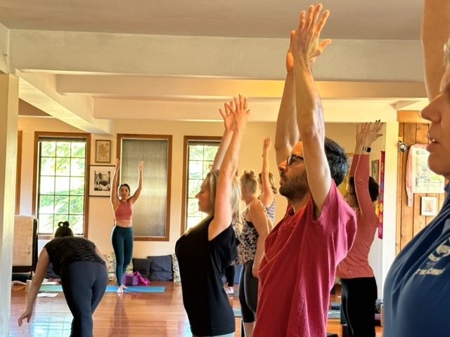 Retreat guests in yoga asana class in the Satsang Room